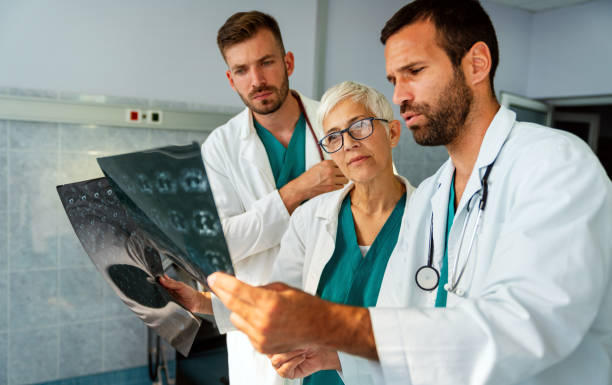 istock Doctors discussing patient's diagnosis looking at x-rays in a hospital 1342024828