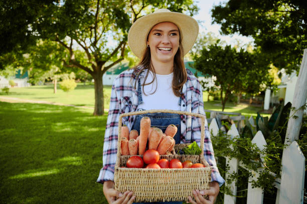istock Caucasian female farmer walking outdoors with basket fo fresh vegetables 1342025485