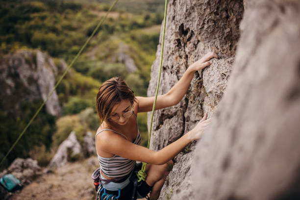 istock Determined young woman rock climbing on the cliff 1342027150