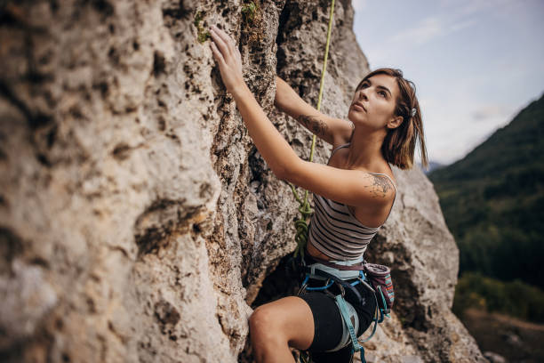 istock Young woman rock climbing on the cliff 1342027299