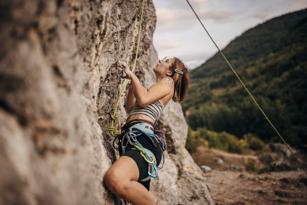 istock Young woman rock climbing on the cliff 1342027463