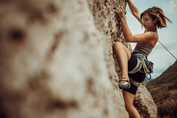 istock Young woman rock climbing on the cliff 1342027492