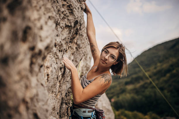 istock Young female rock climbing on the cliff 1342027503