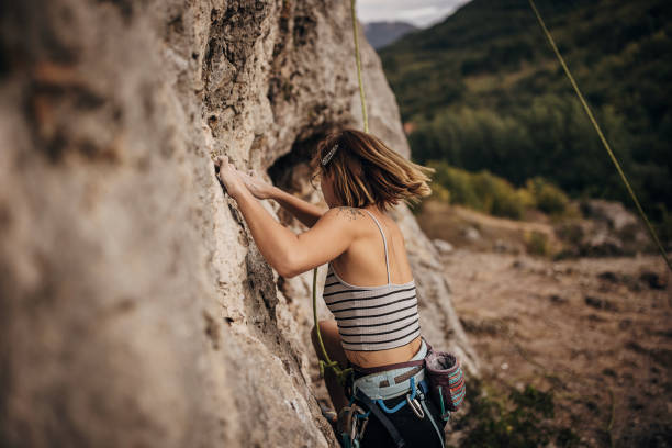 istock Young female rock climbing on the cliff 1342027558