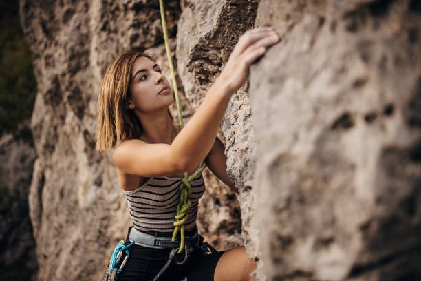 istock Young woman rock climbing on the cliff 1342027593