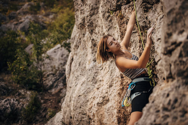 istock Young female rock climbing on the cliff 1342027632