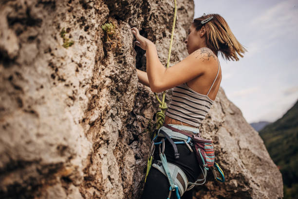 istock Young female rock climbing on the cliff 1342027665