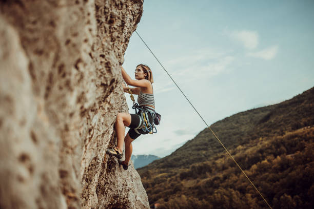 istock Young woman rock climbing on the cliff 1342027692