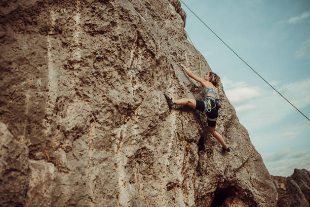 istock Young woman rock climbing on the cliff 1342027767