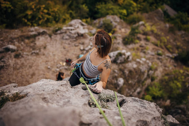 Climber putting on safety equipment outdoors