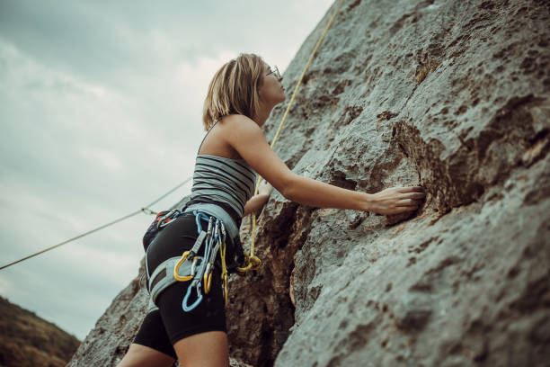 istock Young female rock climbing on the cliff 1342027801