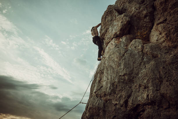 istock Male rock climbing on the cliff 1342028960