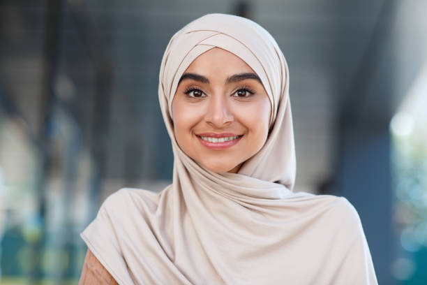 Head shot of beautiful woman student, teacher or blogger Head shot of beautiful woman student, teacher or blogger. Portrait of smiling millennial beautiful nice middle eastern woman in hijab look at webcam, make video call outdoor, close up, free space middle east stock pictures, royalty-free photos & images