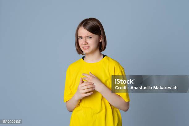 Teen Girl Has Disgusting Expression As Sees Something Unpleasant Stand Over Light Grey Background Ugh How Disgusting Stock Photo - Download Image Now