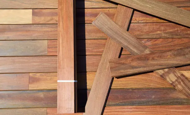 Ipe decking installation with wood slats and flooring background