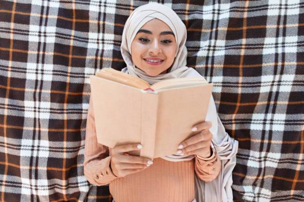 A beautiful woman is holding an office book