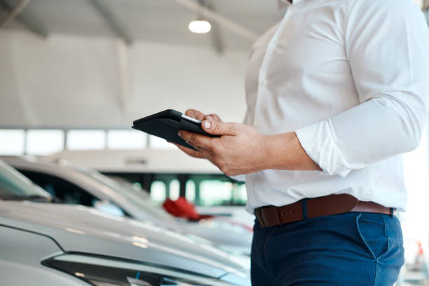 istock Shot of a car salesman using his digital tablet 1342031938