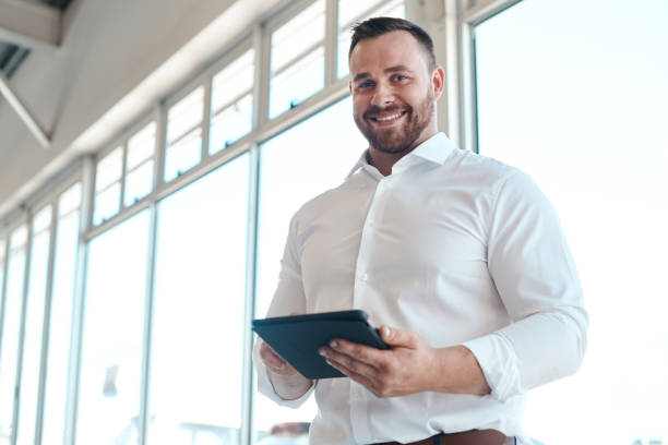 istock Shot of a car salesman using his digital tablet 1342032066