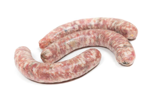 istock Three crude sausages with mushrooms on a white background 1342032333