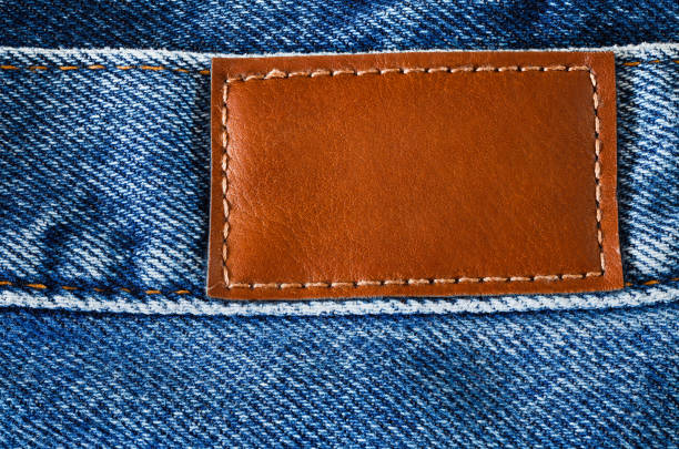 jeans denim, back size, leather label patch on the belt, close-up macro view - leather patch denim jeans imagens e fotografias de stock