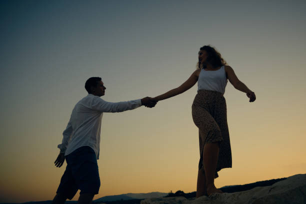 istock Man and woman holding hands 1342034922