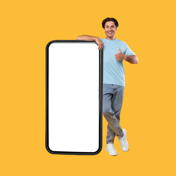 istock Happy man showing white empty smartphone screen and thumbs up 1342035784