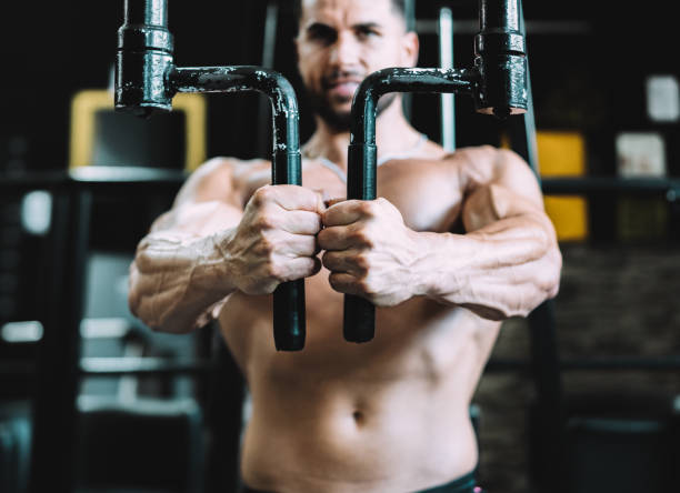 istock Selective focus on the hands of a man exercising on a machine in a gym 1342037987
