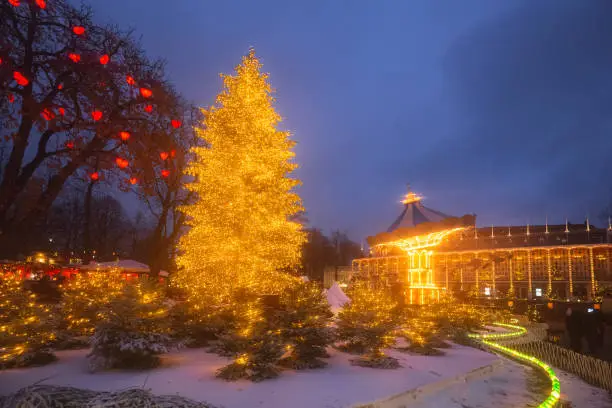Decorative Christmas lights and winter decorations at Tivoli Gardens theme park and carousel in Copenhagen, Denmark.