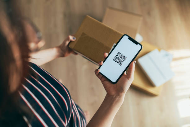 asian woman scanning qr code of parcel - cardboard box package box label imagens e fotografias de stock