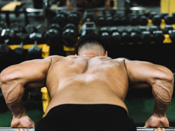 istock Back of a strong man exercising in a gymnasium 1342039759
