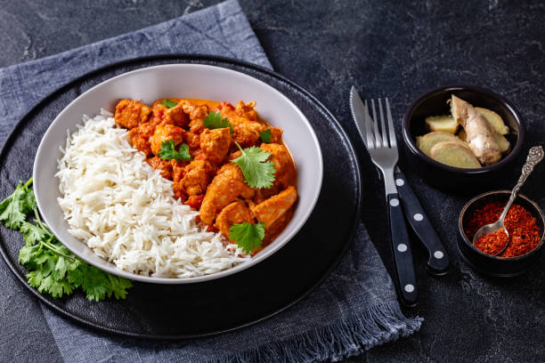 istock butter chicken with long grain rice and coriander, chicken curry in a bowl on a concrete table, english cuisine, horizontal view from above 1342040853