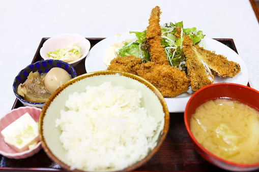 Traditional Japanese Lunch Teishoku as Tonkatsu in Japan. Breaded pork cutlet and sashimi