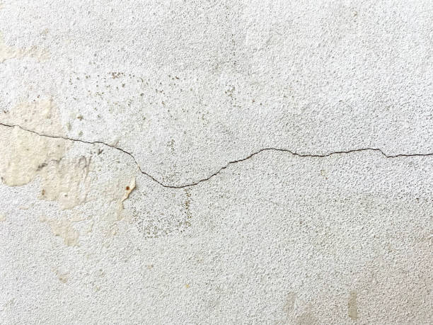 istock Crack concrete wall texture background. closeup white crack wall background in the building 1342041205