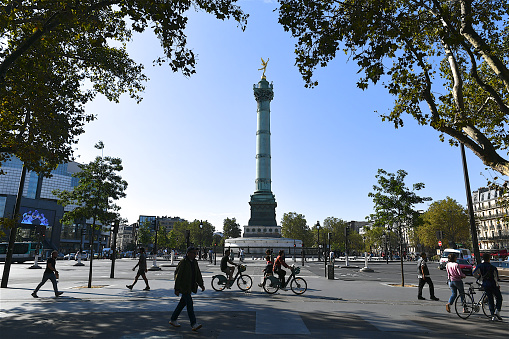 Paris, France-09 18 2021:People walking next to the Place de la Bastille in Paris, France.The Place de la Bastille is a square where the Bastille prison stood until the storming of the French Revolution.No vestige of the prison remains.The July Column stands at the center of the square.