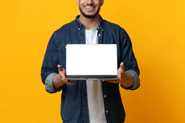 istock Unrecognizable middle-eastern man holding laptop with blank screen 1342042131