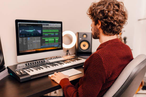 Music producer working in recording studio at home Professional male music producer, composer working in recording home studio. Music production concept. sound technician stock pictures, royalty-free photos & images