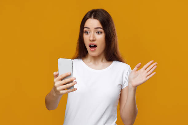 istock Shocked pretty lady looking at cellphone screen 1342043735