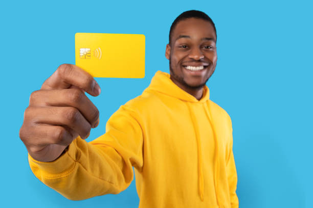 istock African American Man Showing Credit Card On Blue Studio Background 1342043981