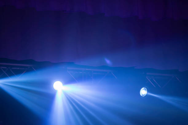 istock Blue rays of a stage spotlight on a dark background. 1342045481