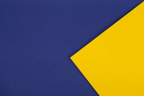 istock Paper blue background with yellow triangle. Colored paper geometric shapes with blue and yellow tones. 1342045667