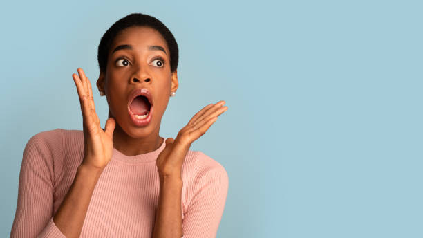 istock Shocking Offer. Surprised Female Looking Aside With Open Mouth And Raised Hands 1342045775