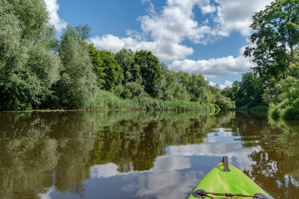 istock Canoeing on a quiet river. Journey in kayaks on the river. Active rest on the water. 1342047284
