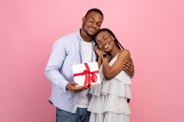 istock Happy black man making surprise for woman giving box 1342050455
