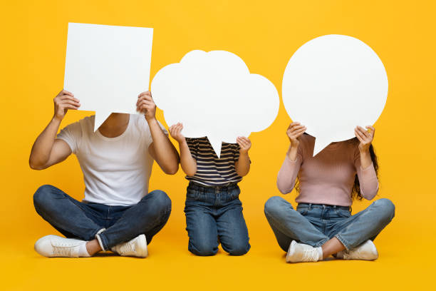 istock Diverse Thoughts. Father, Mother And Little Daughter Holding Different Empty Speech Bubbles 1342051246