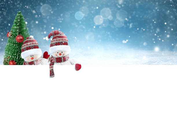 Two Cute Snowmen and christmas tree holding white blank banner on winter landscape background . Christmas and New year greeting card.