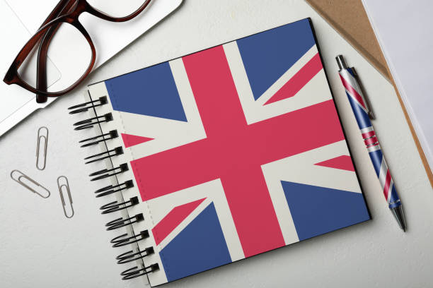 istock Stylish notebook and pen on white table, flat lay. Learning English 1342051599