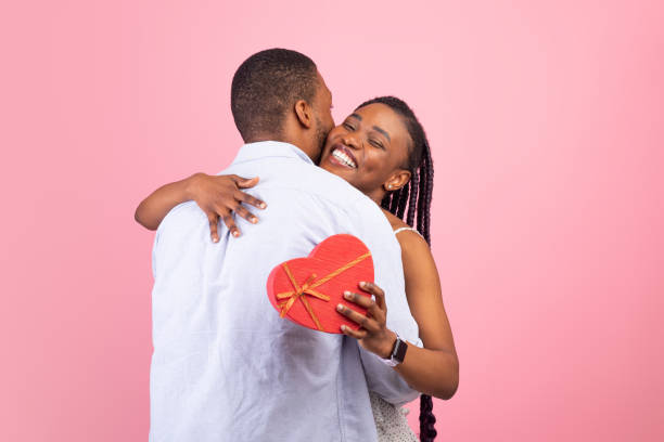 istock Happy black man making surprise for woman giving box 1342052024