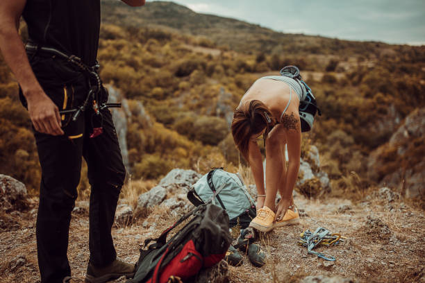 istock Woman is taking off sneakers and getting ready for rock climbing 1342052283