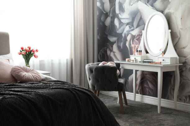 istock Stylish bedroom interior with elegant dressing table and floral wallpaper 1342052959