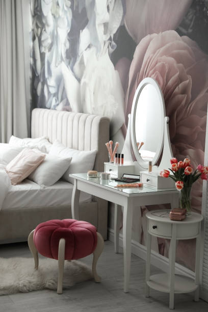 istock Stylish bedroom interior with elegant dressing table and floral wallpaper 1342053943
